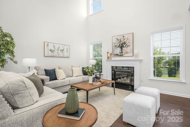 17203 Summers Walk Blvd, Davidson, NC 28036 - living area featuring a fireplace with flush hearth, dark wood-style floors, and a towering ceiling