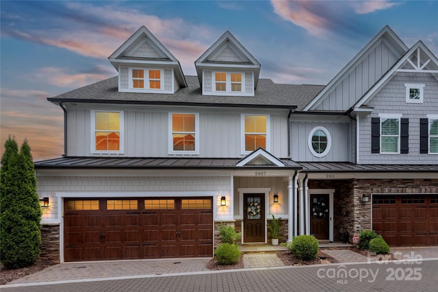 5907 Barrowlands Ct, Charlotte, NC 28210 - view of front of house with a standing seam roof, a shingled roof, an attached garage, and stone siding