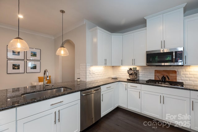 5907 Barrowlands Ct, Charlotte, NC 28210 - kitchen with stainless steel appliances, tasteful backsplash, ornamental molding, arched walkways, and white cabinets