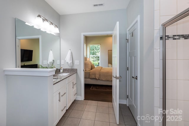 5907 Barrowlands Ct, Charlotte, NC 28210 - full bathroom featuring double vanity, tile patterned flooring, connected bathroom, and an enclosed shower