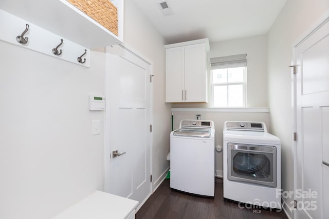 5907 Barrowlands Ct, Charlotte, NC 28210 - laundry area with cabinet space, washing machine and clothes dryer, and dark wood finished floors