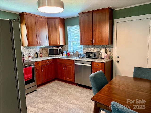 703 Stage St NW, Lenoir, NC 28645 - kitchen with stainless steel appliances, decorative backsplash, light stone countertops, light floors, and ornamental molding