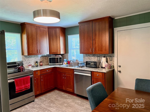 703 Stage St NW, Lenoir, NC 28645 - kitchen featuring appliances with stainless steel finishes, tasteful backsplash, a textured ceiling, crown molding, and light stone counters