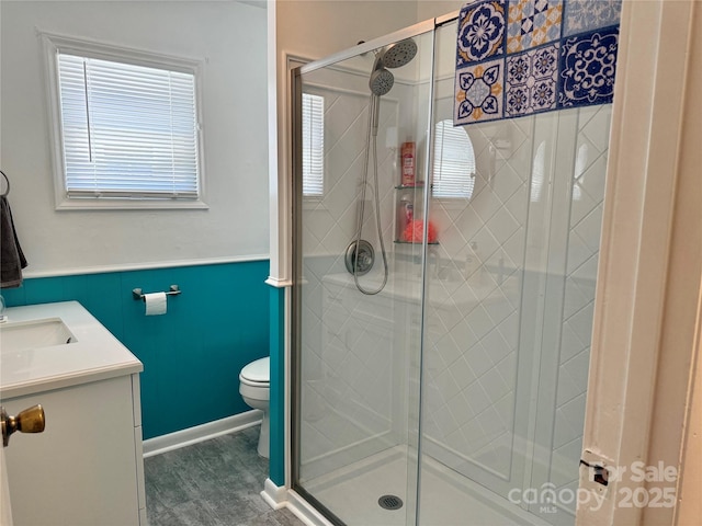703 Stage St NW, Lenoir, NC 28645 - full bath with healthy amount of natural light, a stall shower, vanity, a wainscoted wall, and wood finished floors