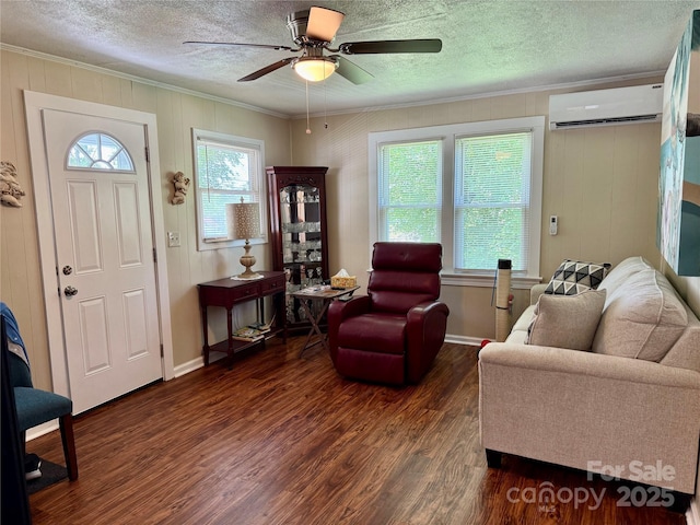 703 Stage St NW, Lenoir, NC 28645 - living area featuring a wall unit AC, crown molding, wood finished floors, ceiling fan, and a textured ceiling