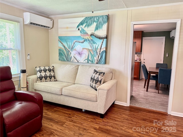 703 Stage St NW, Lenoir, NC 28645 - living room featuring a wall mounted AC, crown molding, dark wood-type flooring, and plenty of natural light