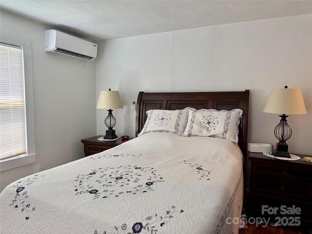 703 Stage St NW, Lenoir, NC 28645 - bedroom with a wall unit AC and a textured ceiling