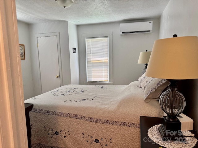 703 Stage St NW, Lenoir, NC 28645 - bedroom featuring a wall mounted AC and a textured ceiling
