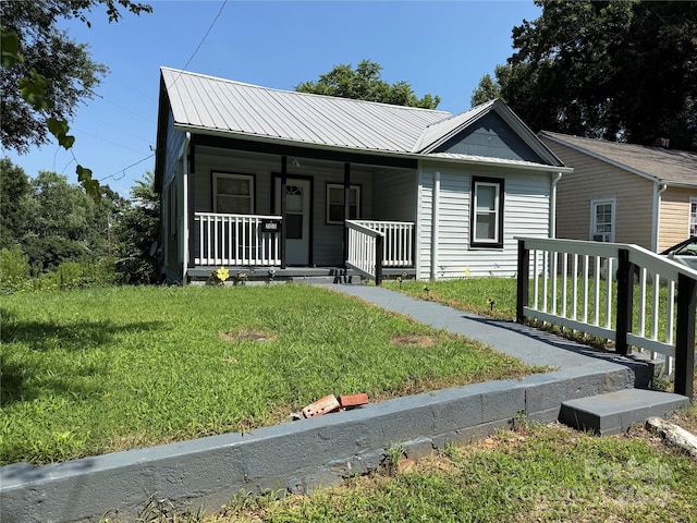703 Stage St NW, Lenoir, NC 28645 - view of front of home featuring a porch, a front lawn, and a metal roof