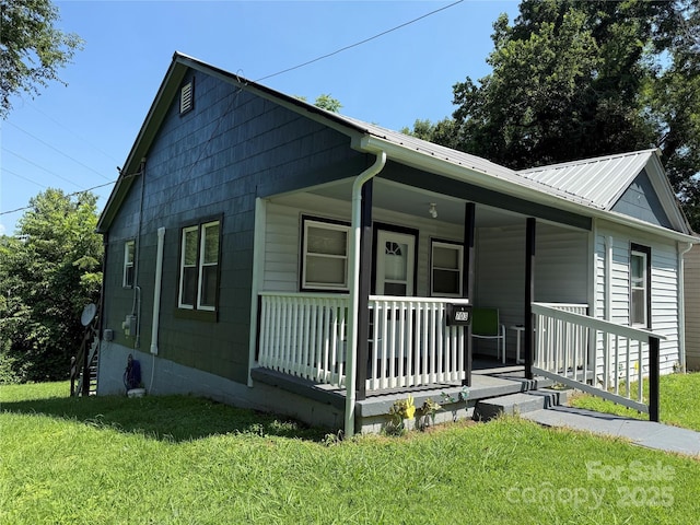 703 Stage St NW, Lenoir, NC 28645 - bungalow featuring covered porch, a front lawn, and a metal roof