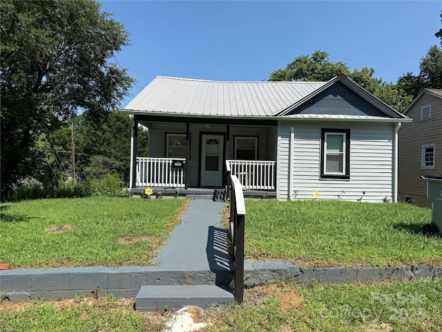 703 Stage St NW, Lenoir, NC 28645 - view of front of house featuring a front yard, covered porch, and a metal roof