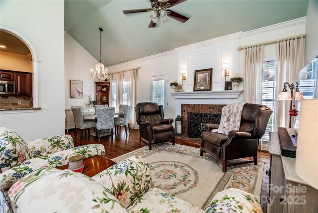 2218 Wednesbury Ct, Kannapolis, NC 28083 - living area with wood finished floors, a chandelier, ceiling fan, a brick fireplace, and high vaulted ceiling