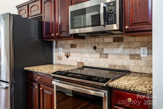 2218 Wednesbury Ct, Kannapolis, NC 28083 - kitchen with stainless steel appliances, decorative backsplash, light stone counters, and dark brown cabinets