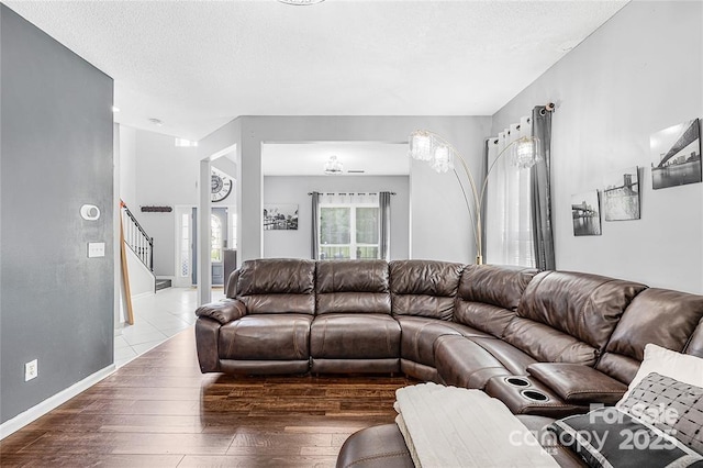 9910 Sandman Ln, Charlotte, NC 28216 - living area featuring stairs, wood-type flooring, and a textured ceiling