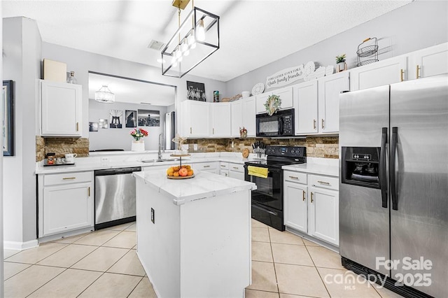 9910 Sandman Ln, Charlotte, NC 28216 - kitchen featuring black appliances, a kitchen island, decorative backsplash, light tile patterned floors, and white cabinetry