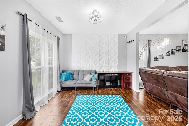 9910 Sandman Ln, Charlotte, NC 28216 - living area featuring hardwood / wood-style flooring, a chandelier, and a textured ceiling