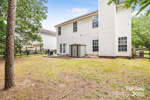 9910 Sandman Ln, Charlotte, NC 28216 - rear view of house with a fenced backyard, a storage unit, and a patio area