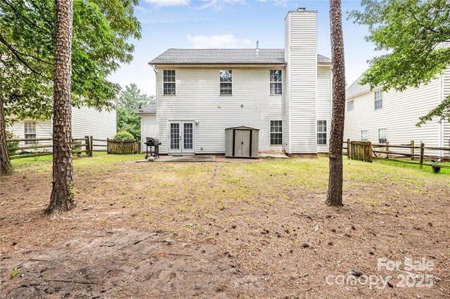 9910 Sandman Ln, Charlotte, NC 28216 - back of house featuring french doors, a fenced backyard, a chimney, and a patio