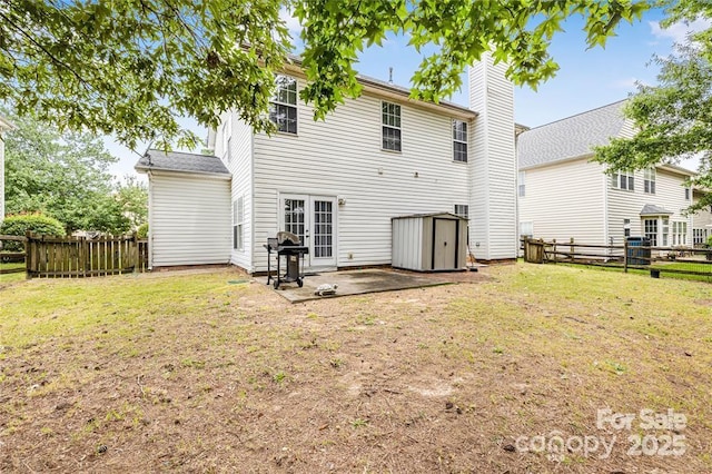 9910 Sandman Ln, Charlotte, NC 28216 - back of house featuring a storage shed, a patio, and a fenced backyard