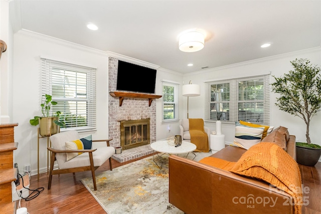 3106 Windstream Ct, Charlotte, NC 28210 - living room featuring wood finished floors, ornamental molding, a brick fireplace, and recessed lighting