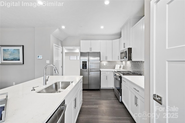7319 Childress Dr SW, Concord, NC 28025 - kitchen featuring appliances with stainless steel finishes, dark wood-type flooring, recessed lighting, white cabinets, and decorative backsplash