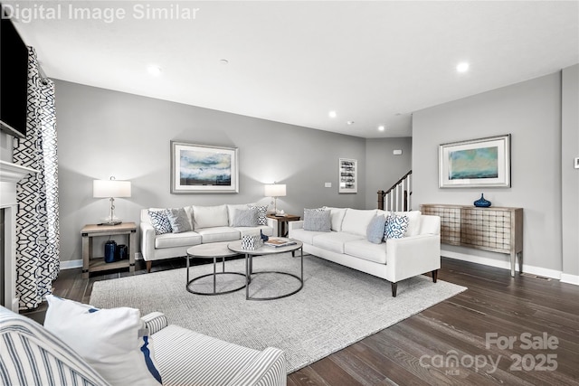 7319 Childress Dr SW, Concord, NC 28025 - living room featuring dark wood-type flooring, stairway, recessed lighting, and a fireplace