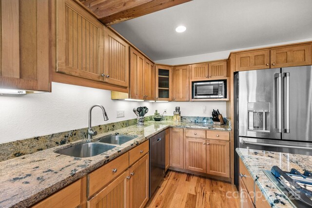 266 Lost Mine Trl Unit 602, Brevard, NC 28712 - kitchen with appliances with stainless steel finishes, light wood-type flooring, glass insert cabinets, brown cabinets, and light stone counters