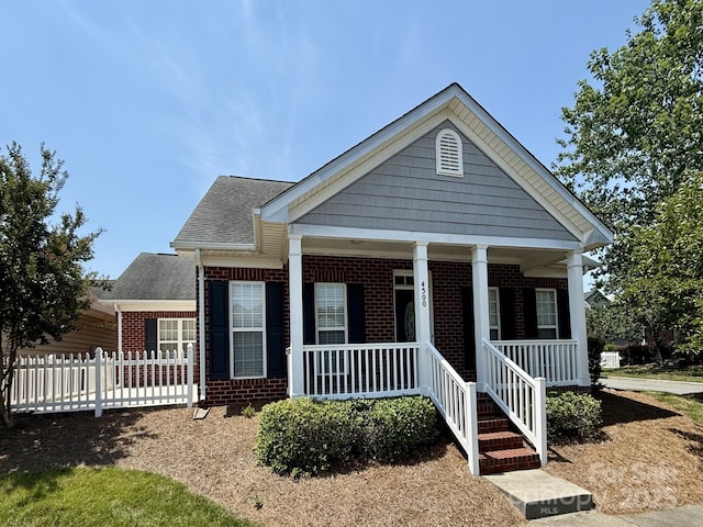 4500 Sages Ave, Indian Trail, NC 28079 - view of front of home featuring brick siding, roof with shingles, and covered porch