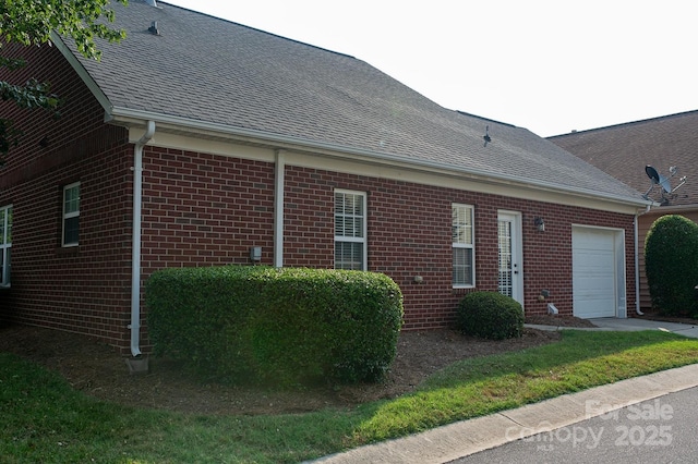 4500 Sages Ave, Indian Trail, NC 28079 - view of side of home with brick siding, an attached garage, and a shingled roof