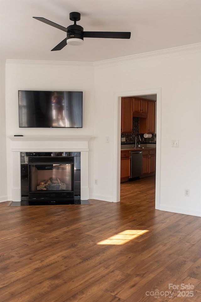4500 Sages Ave, Indian Trail, NC 28079 - unfurnished living room with ceiling fan, a glass covered fireplace, crown molding, and dark wood-style floors
