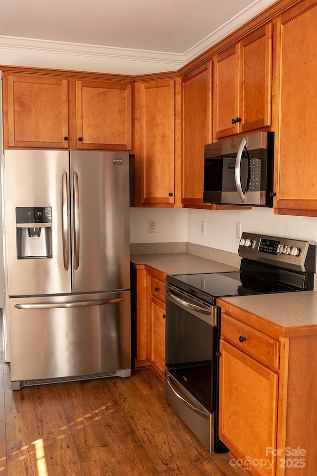 4500 Sages Ave, Indian Trail, NC 28079 - kitchen featuring appliances with stainless steel finishes, brown cabinetry, dark wood finished floors, and light countertops
