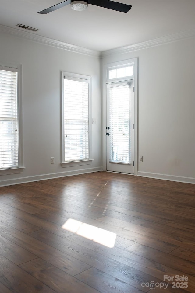 4500 Sages Ave, Indian Trail, NC 28079 - empty room with crown molding, a ceiling fan, dark wood-style flooring, and plenty of natural light