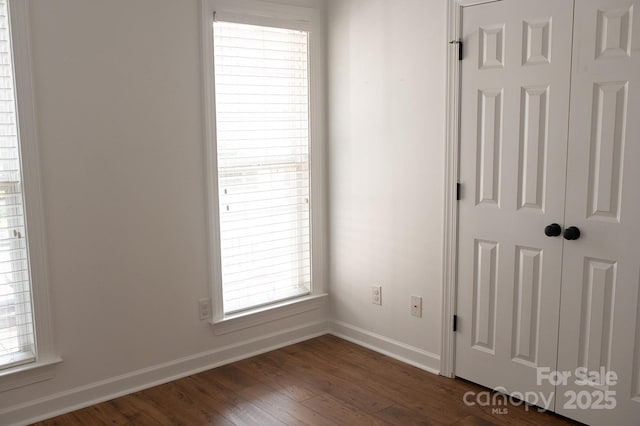 4500 Sages Ave, Indian Trail, NC 28079 - unfurnished bedroom with baseboards and dark wood-type flooring