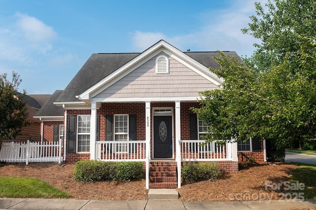 4500 Sages Ave, Indian Trail, NC 28079 - view of front of property with brick siding, a porch, and roof with shingles