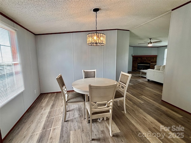 2268 Arrowwood Dr, Hickory, NC 28601 - dining space with plenty of natural light, wood finished floors, a ceiling fan, ornamental molding, and a textured ceiling