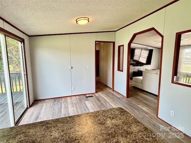 2268 Arrowwood Dr, Hickory, NC 28601 - unfurnished room featuring ornamental molding, wood finished floors, healthy amount of natural light, a textured ceiling, and arched walkways
