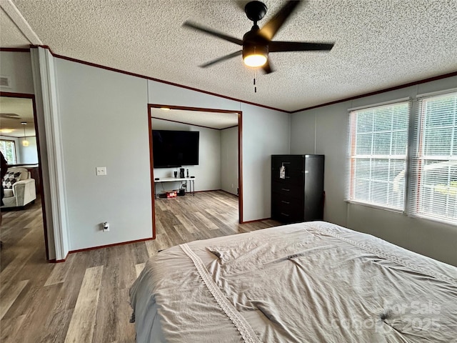 2268 Arrowwood Dr, Hickory, NC 28601 - bedroom featuring crown molding, wood finished floors, a textured ceiling, and ceiling fan