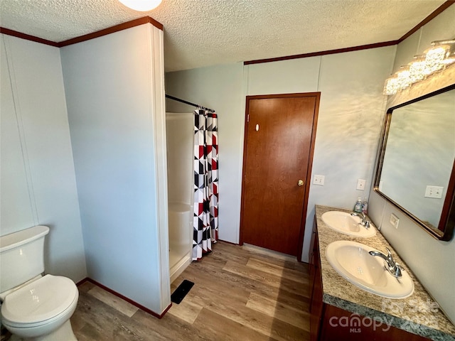 2268 Arrowwood Dr, Hickory, NC 28601 - bathroom featuring wood finished floors, a textured ceiling, curtained shower, double vanity, and ornamental molding