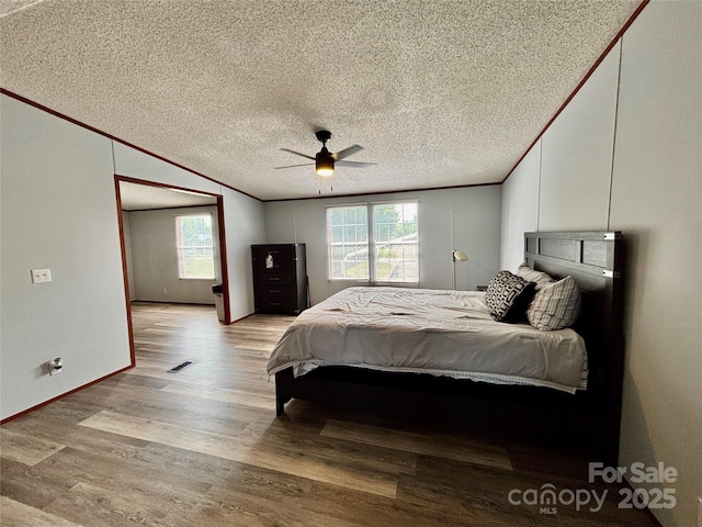 2268 Arrowwood Dr, Hickory, NC 28601 - bedroom with multiple windows, ornamental molding, a textured ceiling, light wood-type flooring, and ceiling fan