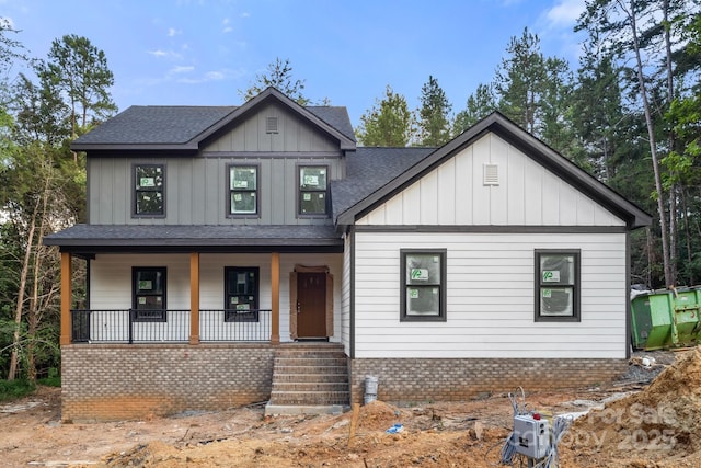 4641 Yellow Poplar Ln, Concord, NC 28025 - modern inspired farmhouse with a porch, roof with shingles, board and batten siding, and brick siding