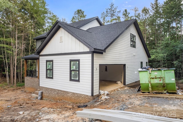 4641 Yellow Poplar Ln, Concord, NC 28025 - view of side of property with a shingled roof, board and batten siding, and brick siding