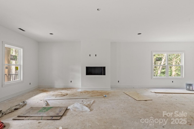 4641 Yellow Poplar Ln, Concord, NC 28025 - unfurnished living room featuring plenty of natural light and a fireplace