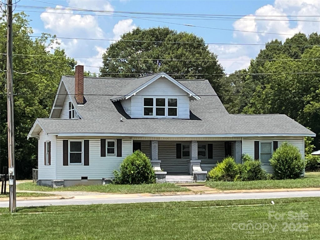 509 E Grover St, Shelby, NC 28150 - view of front of home with a chimney, covered porch, a front lawn, and a shingled roof