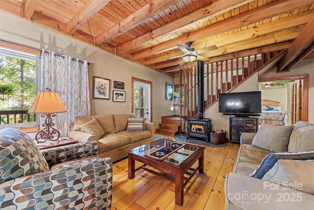 747 Bear Cove Cir, Bryson City, NC 28713 - living area featuring a wood ceiling with exposed beams, a wood stove, hardwood / wood-style flooring, a ceiling fan, and stairs