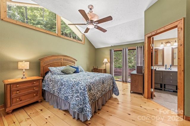 747 Bear Cove Cir, Bryson City, NC 28713 - bedroom with vaulted ceiling, a textured ceiling, light wood-type flooring, access to exterior, and connected bathroom