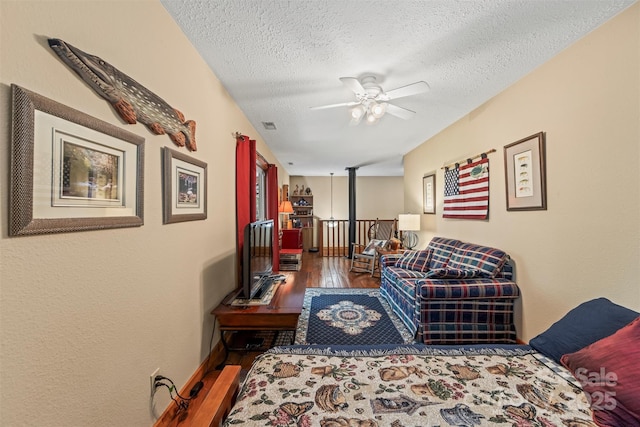 747 Bear Cove Cir, Bryson City, NC 28713 - living room with wood finished floors, a ceiling fan, and a textured ceiling