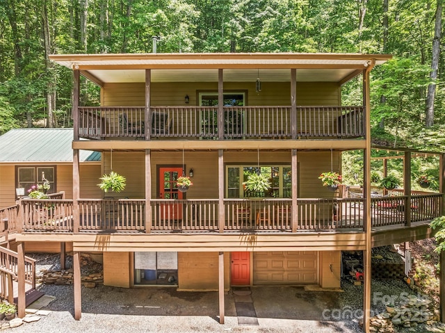 747 Bear Cove Cir, Bryson City, NC 28713 - view of front of property with a balcony, an attached garage, a view of trees, and driveway