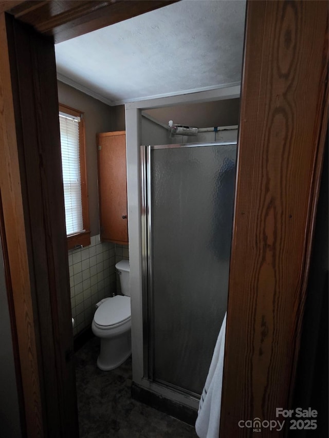 7335 US Highway 52, Salisbury, NC 28146 - bathroom with a shower stall, tile walls, crown molding, and a wainscoted wall