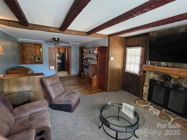 7335 US Highway 52, Salisbury, NC 28146 - carpeted living room with a stone fireplace, beam ceiling, and ceiling fan