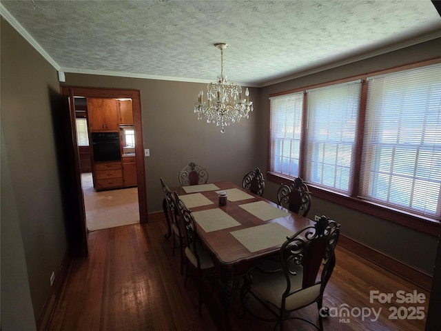 7335 US Highway 52, Salisbury, NC 28146 - dining space featuring dark wood-style floors, a chandelier, a textured ceiling, and ornamental molding